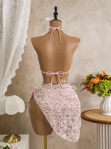 Detailed back view of a pink three-piece bikini set featuring a floral lace sarong cover-up