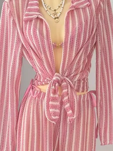 Detailed view of pink striped knit four-piece beachwear set featuring a tie-front design