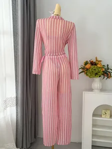 Back view of a stylish pink and white striped beach vacation outfit displayed on a mannequin