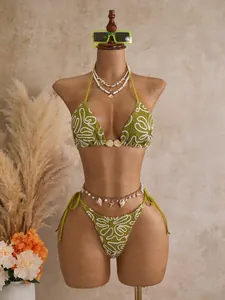 Green textured bikini swimsuit with abstract wavy print styled on mannequin for resort