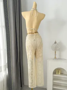 Detailed back view of chic leaf pattern lace trousers from a three-piece bikini set