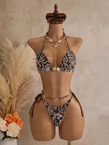 Sexy brown bikini set with white swirl patterns on mannequin for beach vacation.