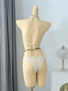 Back detail of white crochet string bikini set with decorative starfish waist chain