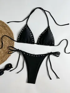 Detailed view of stylish black halter bikini set with silver metal studs and adjustable string ties