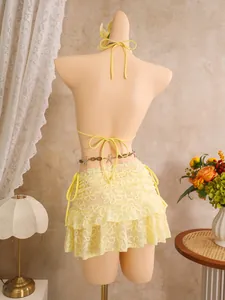 Rückansicht eines gelben Bikini-Sets mit floraler Spitze und passendem Strandrock