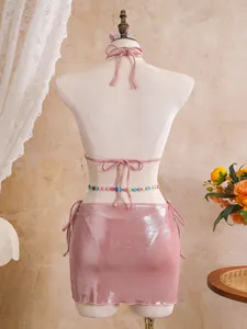 Back view of pink shiny three-piece bikini set featuring metallic fabric and tie details