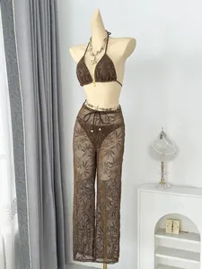 Detailed view of brown leaf pattern crochet three-piece bikini set with mesh wide-leg pants