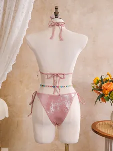 Back view of a shimmering pink metallic bikini set with tie-side details and beads.