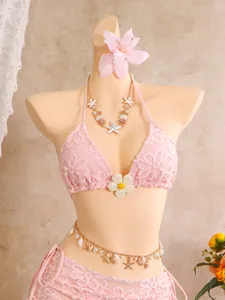 Detaillierte Ansicht des pinken Bikinis mit Blumenstickerei und 3D-Gänseblümchen.