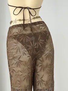 Detailed macro view of the brown leaf pattern sheer crochet knit beach cover-up pants.