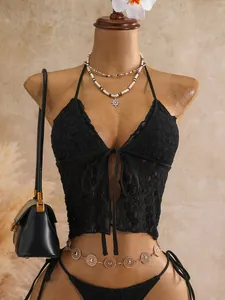 Λεπτομέρεια από μαύρο δαντελένιο μπικίνι halter με δέσιμο μπροστά σε γυναικείο μανεκέν
