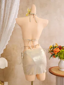 Back view of sexy shiny gold three-piece bikini set with shell chain belt detail