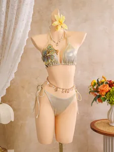 Elegant champagne gold shimmering bikini set with blue 3D floral embroidery on a mannequin