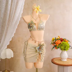 Detailed view of shimmering champagne bikini set with ornate floral embroidery.