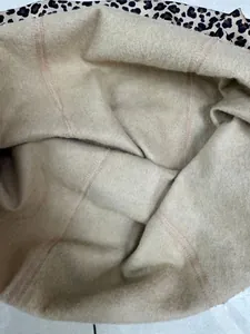 Detailed macro view of the warm beige fleece lining inside leopard print leggings