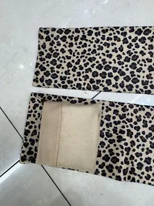 Close-up detail of leopard print leggings showing the warm soft brushed fleece lining inside