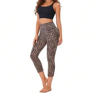 Detailed view of leopard print high-waisted capri leggings on a model with black top