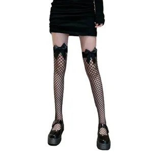 Close-up detail of sexy black fishnet thigh-high stockings featuring elegant satin bow accents
