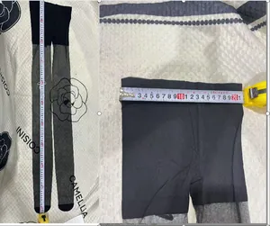 Close-up detail of waist and length measurement for black and grey pantyhose tights