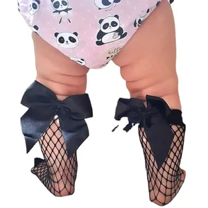 Toddler girl fishnet knee high socks with large black satin bows on white background