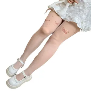 Elegant white butterfly print tattoo effect pantyhose styled with vintage Mary Jane shoes