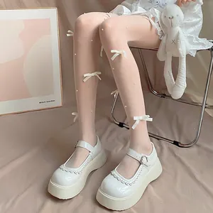 Detailansicht süßer weißer Lolita-Strumpfhosen mit zarten Schleifenknoten und Perlen