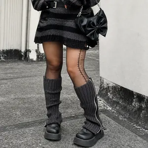 Detailed view of dark grey knit leg warmers with functional side zipper and Y2K aesthetic