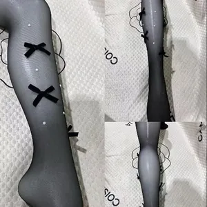 Transparente schwarze Lolita-Strumpfhose mit Samtschleifen und Perlenverzierung