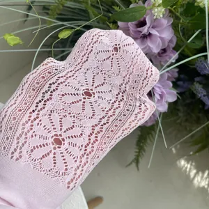 Detail shot of pink lace mesh girl's tights showing intricate flower pattern