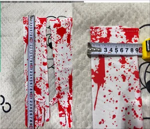 Detail view showing length and width measurement of white Halloween blood splatter gloves