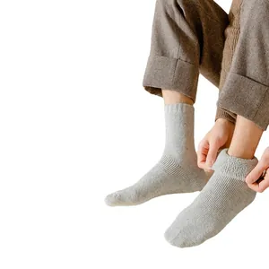 Cozy thick gray winter thermal socks for men and women, warm knitted crew socks.