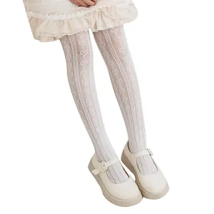 Close-up of white heart jacquard pattern on girls summer breathable lace stockings