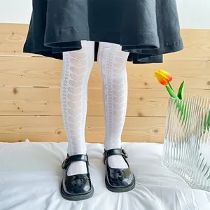Detail view of white girls' mesh tights with heart patterns in a princess style.