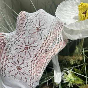 Close-up detail of white floral lace mesh pattern on breathable girls summer stockings