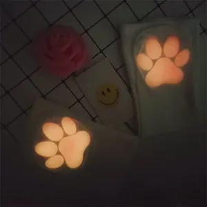 Detail shot of luminous 3D cat paw silicone pads on Japanese style velvet socks