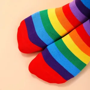 Detailed close-up showing the vibrant rainbow striped pattern of these cotton over-the-knee socks