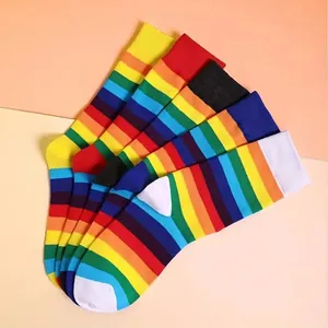 Close-up of vibrant rainbow striped over-the-knee cotton socks for dancing and cosplay.