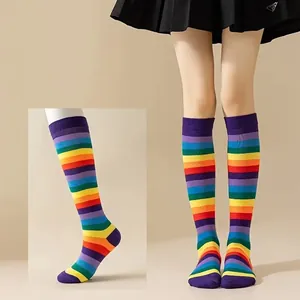 Detail view of colorful rainbow striped over-the-knee cotton socks for festive outfits