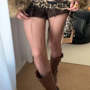 Close-up detail of sexy hollow lace fishnet stockings featuring a diamond pattern on legs