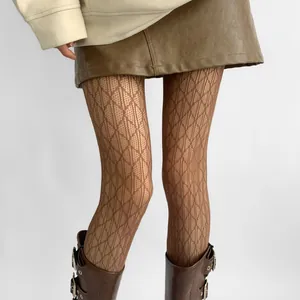 Macro detail of hollow lace tights featuring an elegant argyle diamond grid pattern in brown