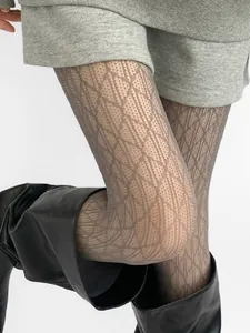 Detailed view of hollow lace patterned tights with stylish rhombic mesh design
