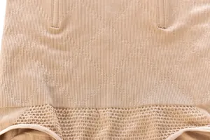 Close-up of seamless high-waisted shapewear fabric with diamond texture and reinforced bones