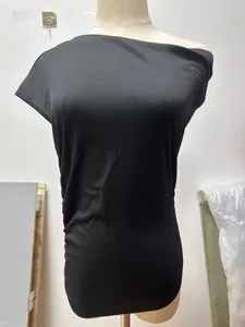 Close-up detail of the black ribbed fabric texture on a slim fit asymmetric neck t-shirt