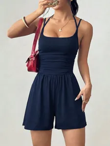 Close-up of navy blue square neck romper featuring ruched waist and wide leg shorts
