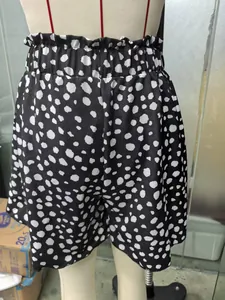 Close-up of high-waisted dalmatian print A-line shorts with ruffled elastic waist