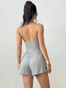 Back view of a grey spaghetti strap romper featuring a cinched waist and wide legs