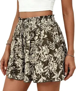 Detail of high-waisted A-line shorts with elegant floral print and elastic waist band.