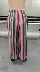 Detailed view of fashionable pink and black striped wide-leg pants with elastic waist