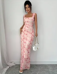 Detailed view of elegant pink floral maxi dress featuring a slim fit and square neckline.
