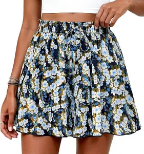 Detailed view of the blue floral print and elastic drawstring waist of these A-line shorts.